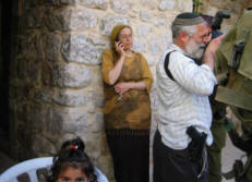 08-03-19 Israeli settlers (on left the daughter of Rabbi Moshe Levinger and on right David Wilder, one of the Hebron settler community leaders) in a Palestinian home. Shortly afterwards the Israeli military evicted the family. 