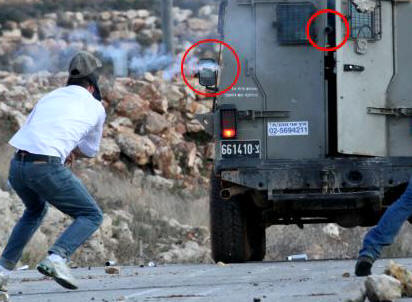 Mustafa Tamimi (left) a moment before his injury. Circled in red are the barrel of the gun and the projectile that hit him. Picture credit: Haim Scwarczenberg